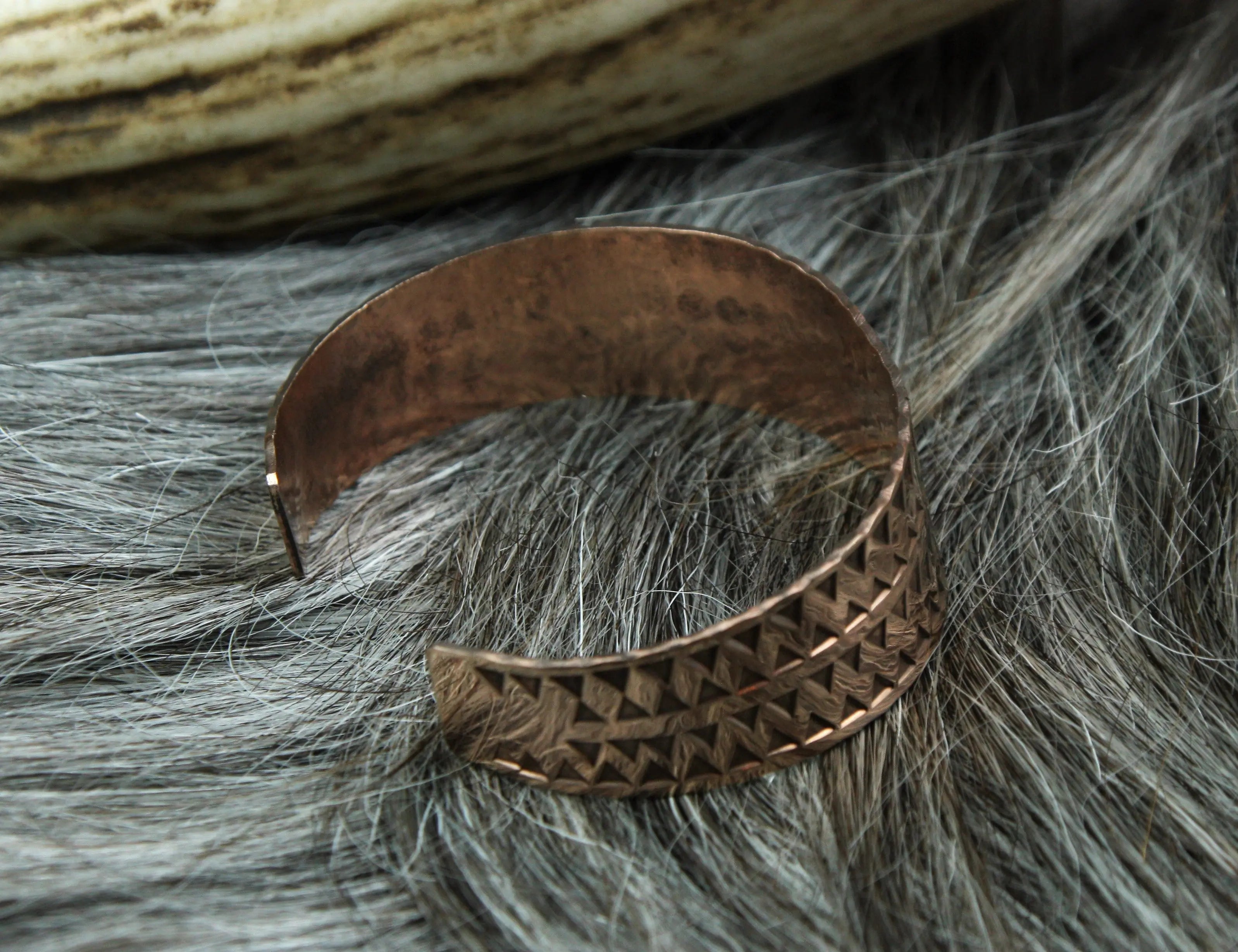 The Viking money arm ring is stamped in a beautiful rose gold coloured bronze and punched with a 3 mm triangle.